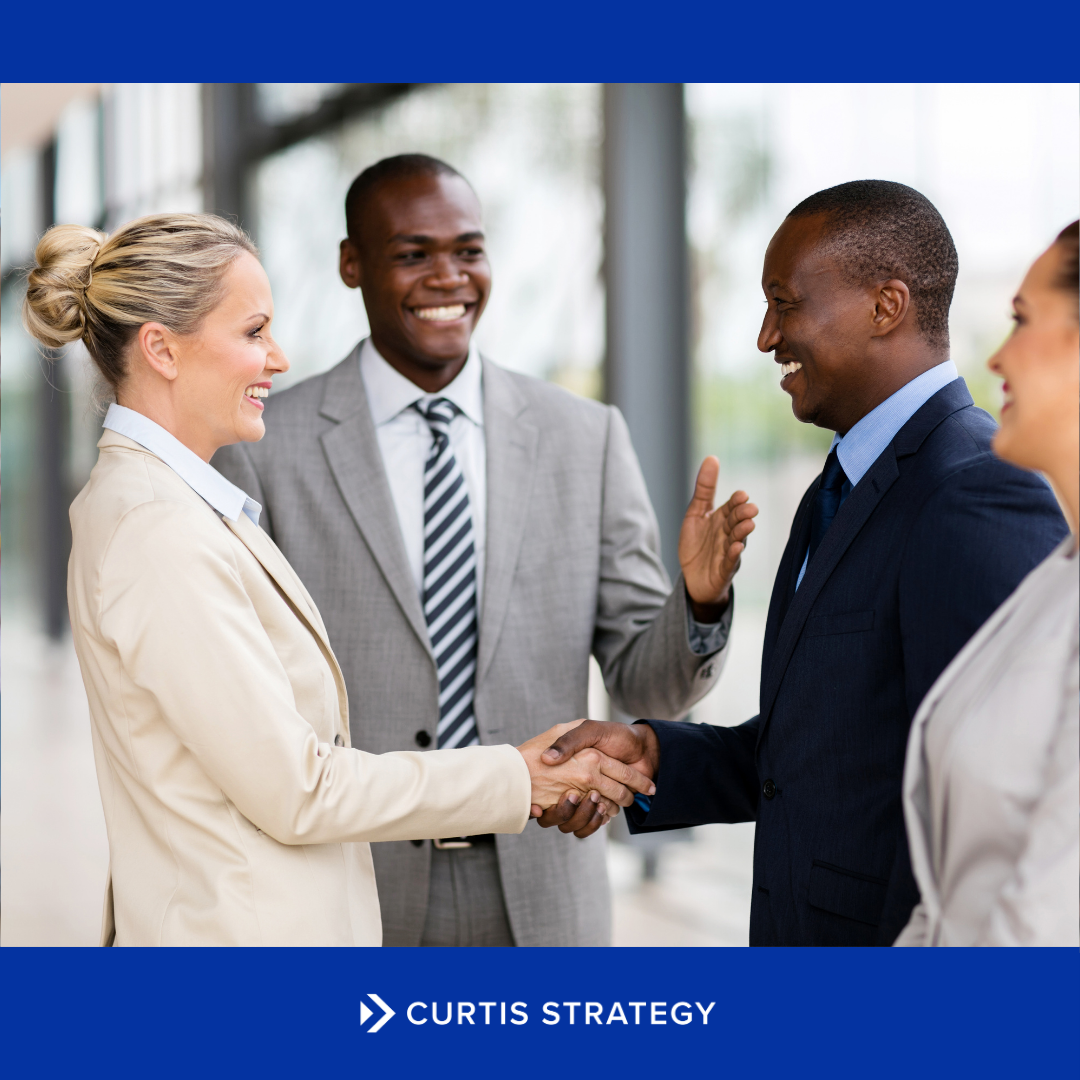Two leaders shaking hands to symbolize partnership in a nonprofit merger.