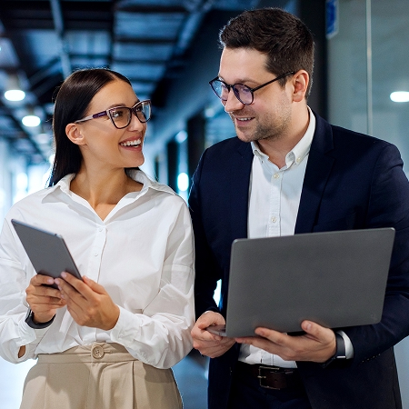 Two Business People walking down hallway