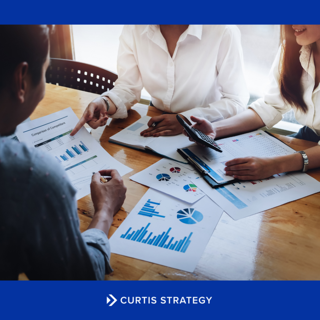 Nonprofit CEO and board members meeting to evaluate nonprofit structural options and long-term strategic sustainability.